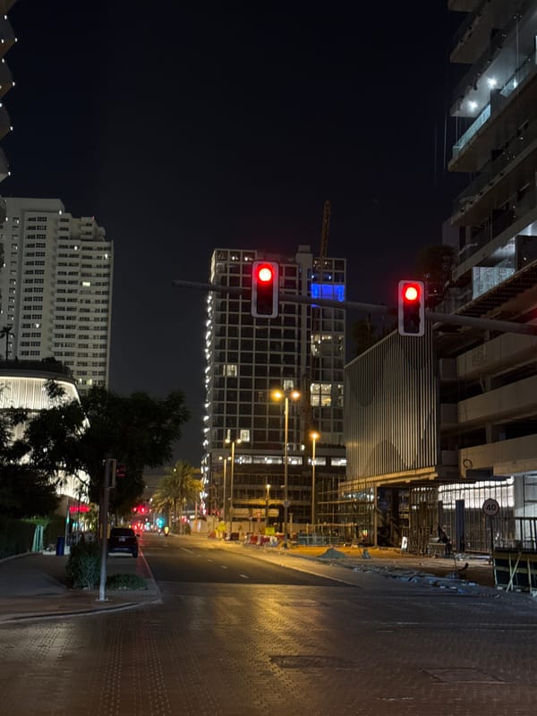 Night stroll through a busy Dubai neighborhood, cranes and all