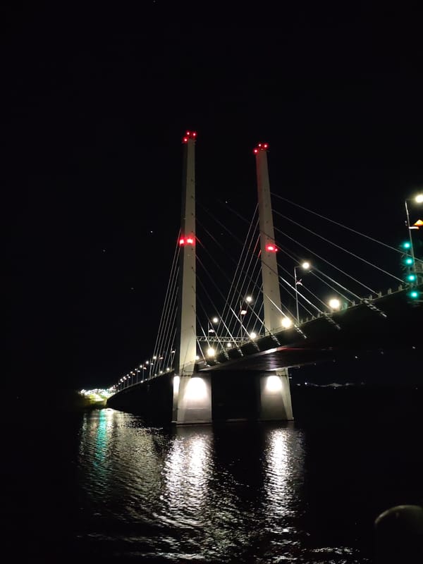 Nighttime documentation of illuminated October Bridge in Cherepovets, Russia