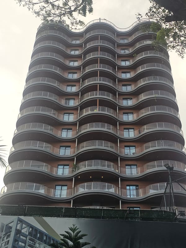 Modern wavy-facade high-rise building observed in Accra
