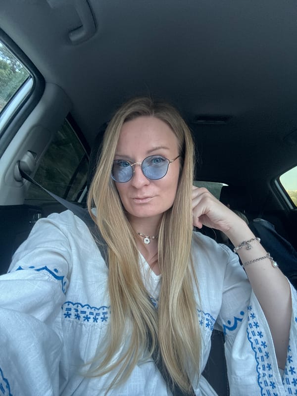 Woman takes selfie during mountain road drive