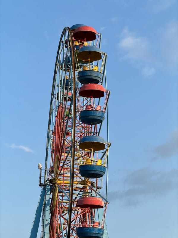 Low-angle sky views around an outdoor amusement area