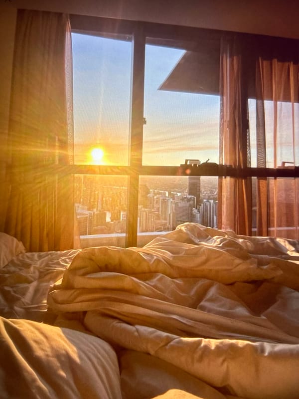 Sunrise spills through a bedroom window over a Bulgarian city