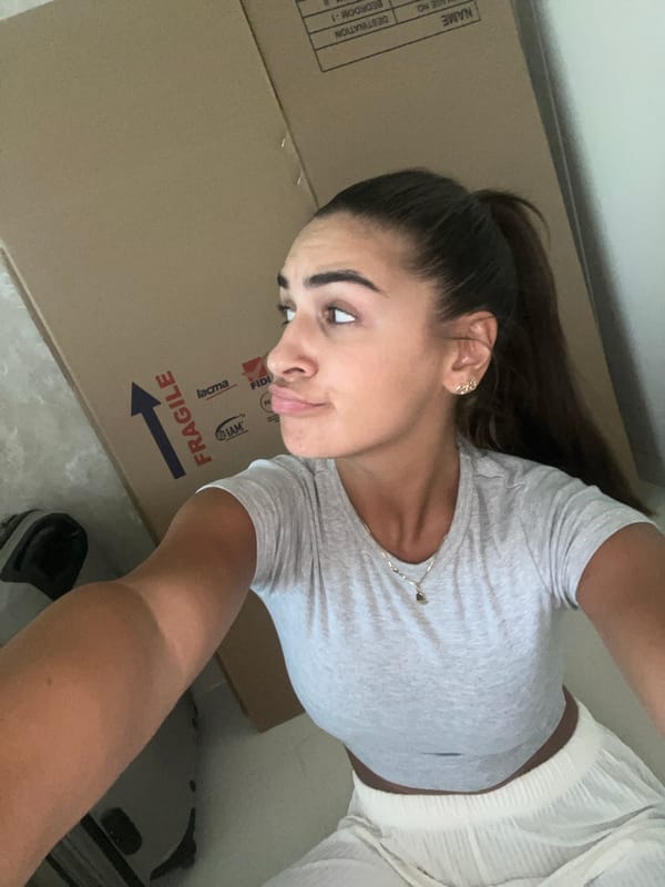 Woman poses with moving box in Dubai