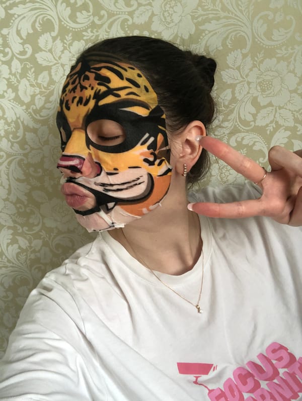 Person enjoys tiger-print face mask during skincare routine in Russia