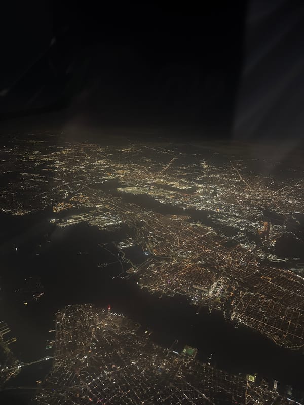 Nighttime aerial view captures illuminated city grid from aircraft