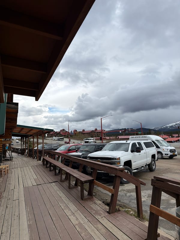 Nighttime deck view captured at Denali Park shows vehicles, buildings