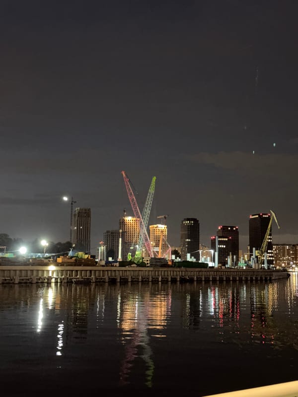 Moscow riverfront at night — cafés, cranes, and reflections