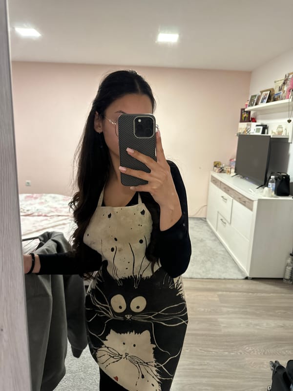 Woman takes selfie in pink-walled room in Dupnitsa