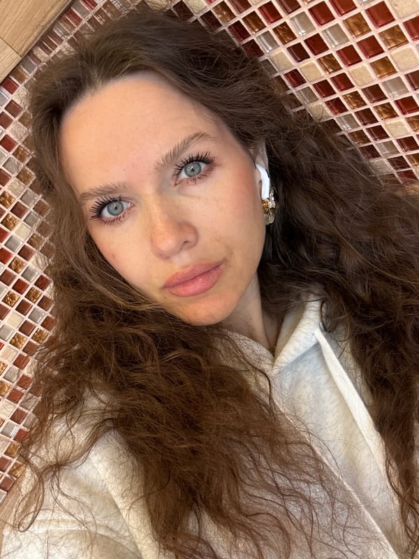 Woman eats salad while wearing earbuds in Moscow