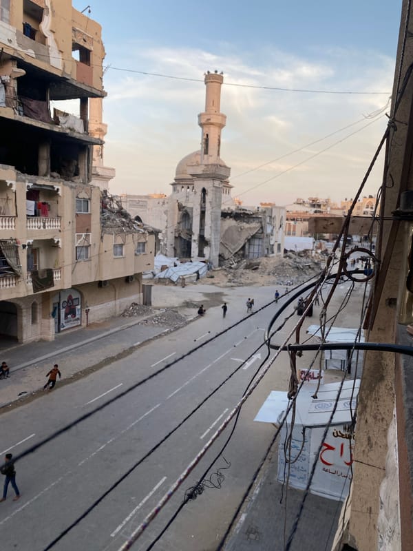 Children play amid damaged buildings in Khan Yunis
