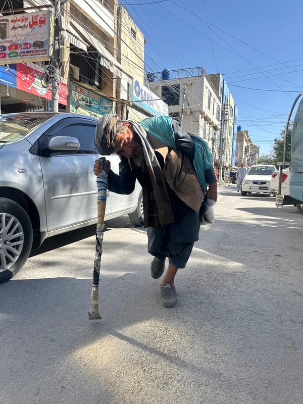 Street scenes with elderly pedestrian, banner displays in Quetta
