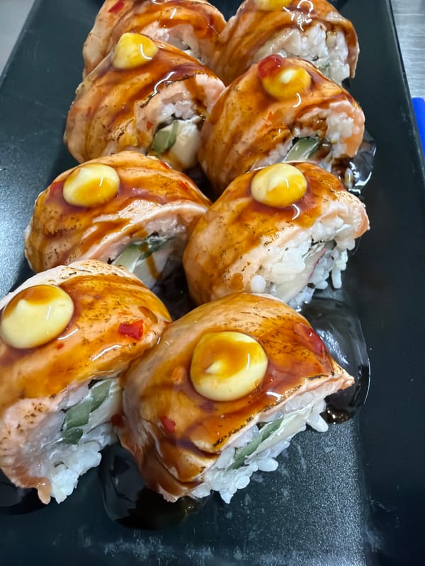 Salmon sushi photographed on black plate in Pleven, Bulgaria