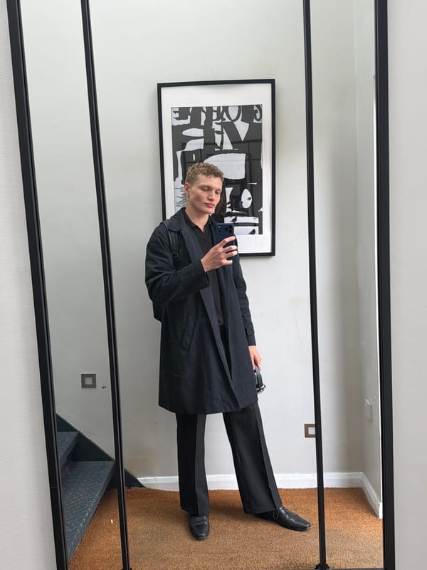 Young man takes mirror selfie indoors in London