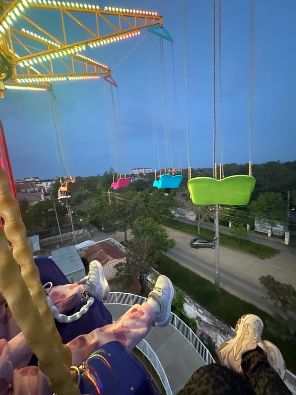 Nighttime swing ride view captured at Ukrainian amusement park