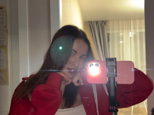 Woman takes selfies in red sweatshirt, Krasnodar apartment