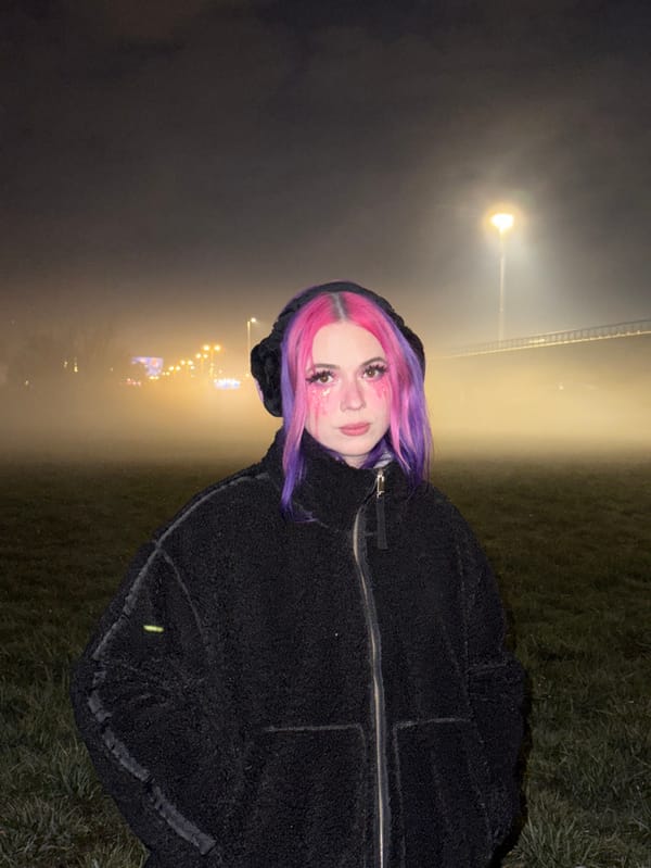 Woman with colorful hair walks through foggy Zagreb night