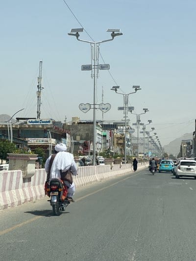 Ordinary traffic flows through Kandahar streets on sunny morning