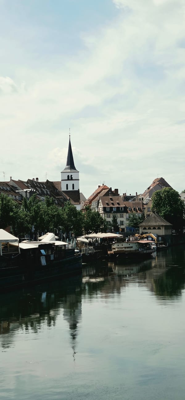 Sunny morning in Strasbourg's historic center, canals and cyclists