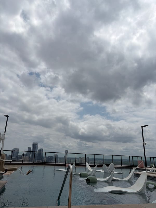 Rooftop view captures Austin skyline under dramatic evening clouds