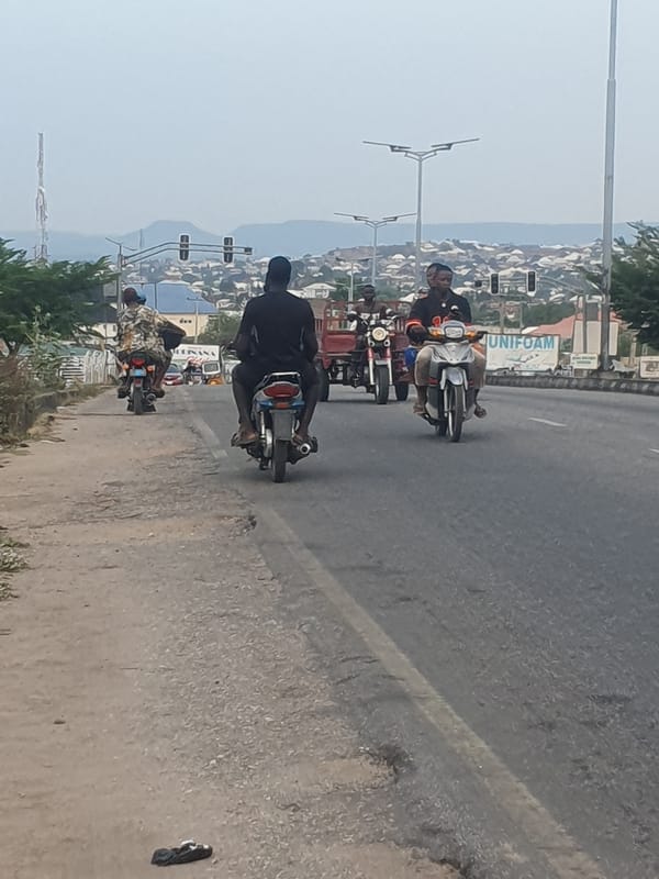 Motorcycles travel busy street in Lokoja, Nigeria