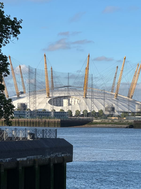 Painted biblical stones arranged on the Thames foreshore near the O2