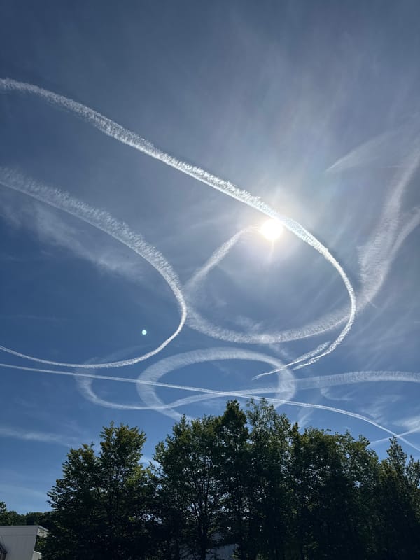 Skies over Salach laced with contrail patterns on clear morning