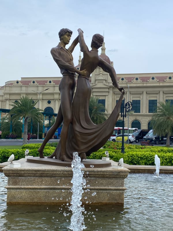 Nha Trang resort complex with fountain, wet flowers, and classical architecture