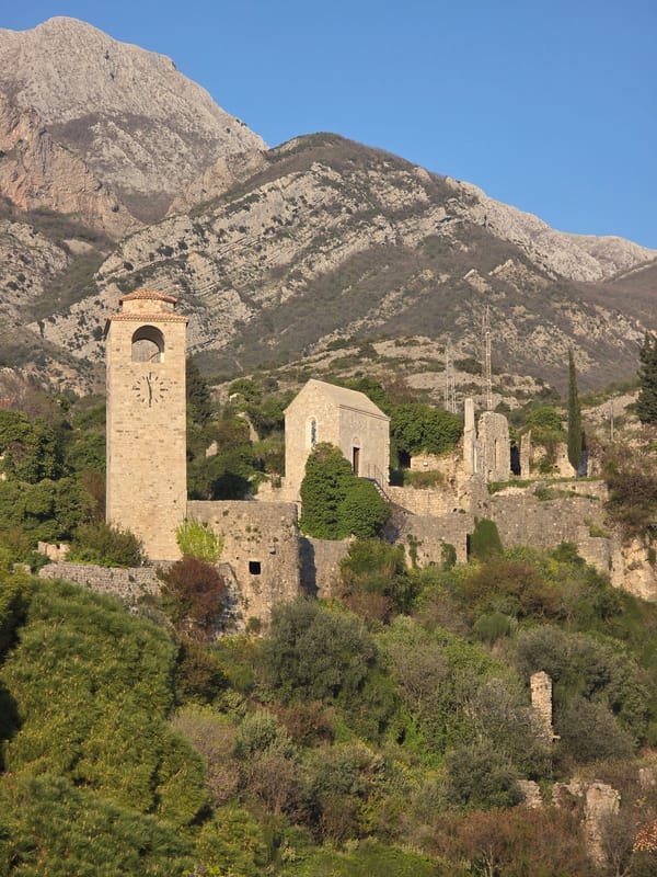 Tourist documents ancient ruins and clock tower in Stari Bar