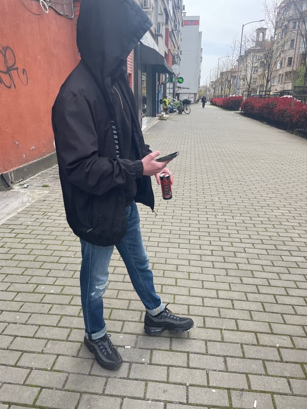 Person walks Burgas streets, enjoys energy drink indoors
