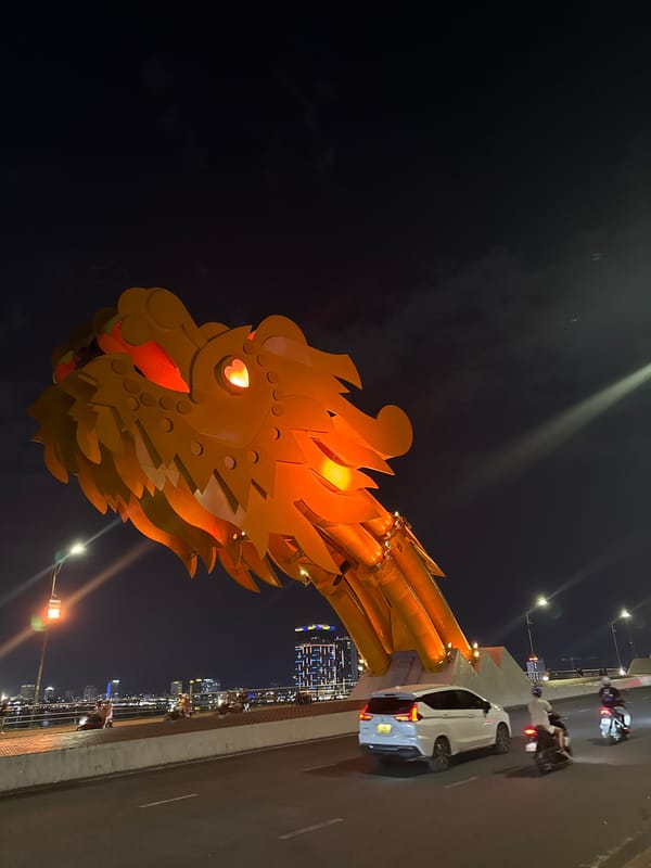 Dragon Bridge glows over Da Nang's Han River at night