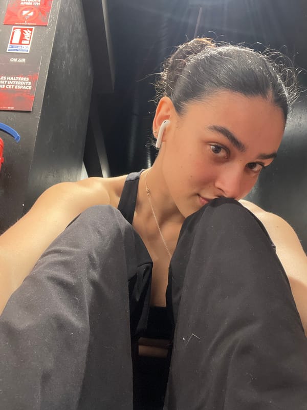 Woman takes selfie on exercise mat at Lyon track