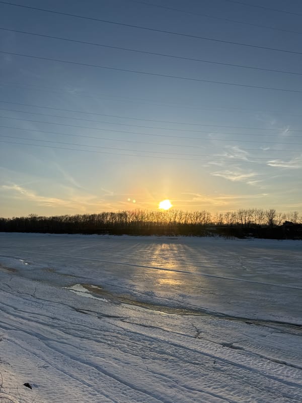 Winter sunset selfies captured along frozen river in Chaikovsky