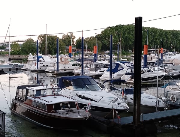 Marina town at dusk, boats docked and streets quiet