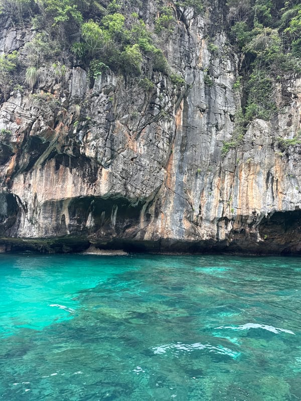 Longtail boats and limestone cliffs at Haad Yao