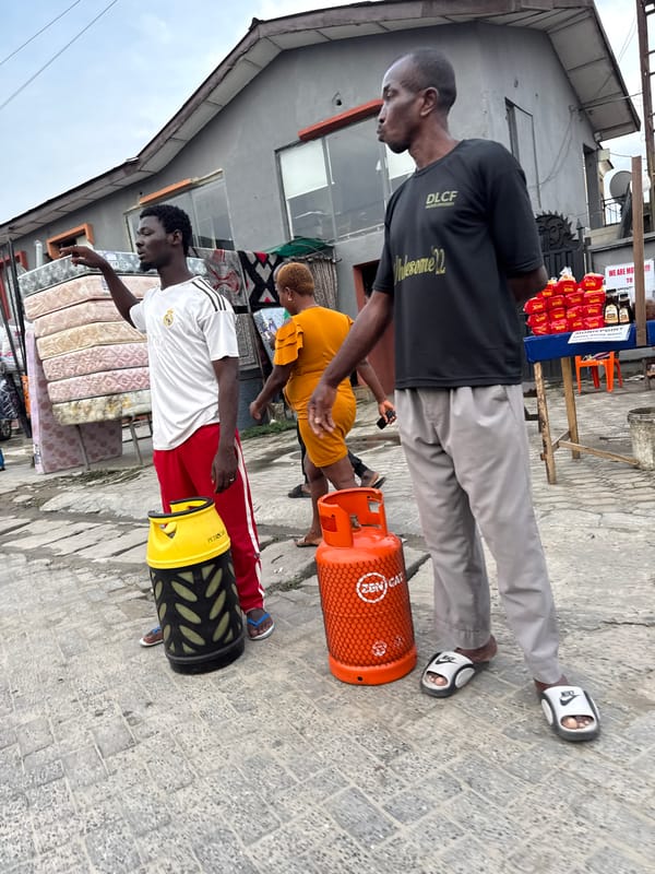 Everyday street activity outside shops in Ado, Nigeria