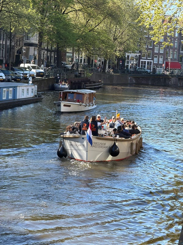 Amsterdam canal boats cruise under sunny skies Thursday afternoon