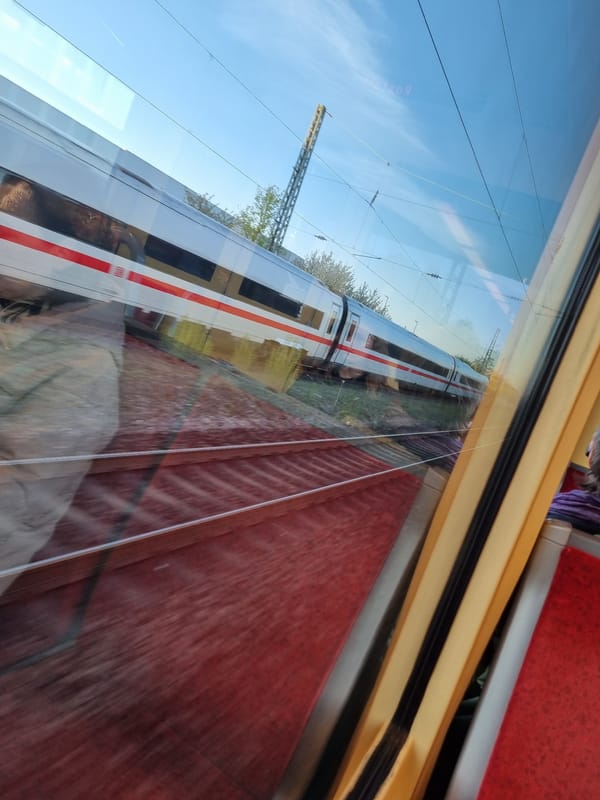 Train passenger spots passing locomotive near Ötigheim, Germany