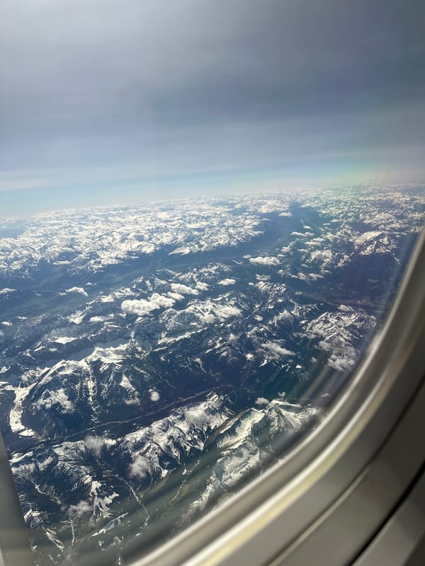 Aerial view captures snow-capped Bavarian mountains from airplane window