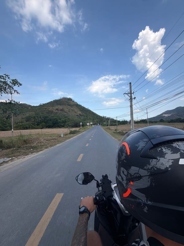 Motorcyclist travels paved road in Dien Tho, Vietnam