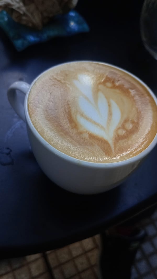 Coffee shop scene with latte art captured in Buenos Aires
