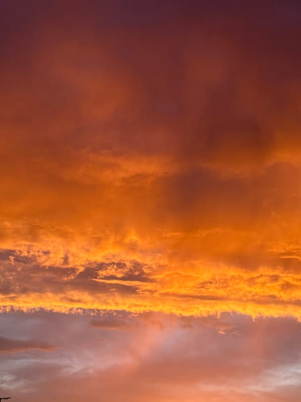 Colorful sunset displays vibrant hues across urban sky