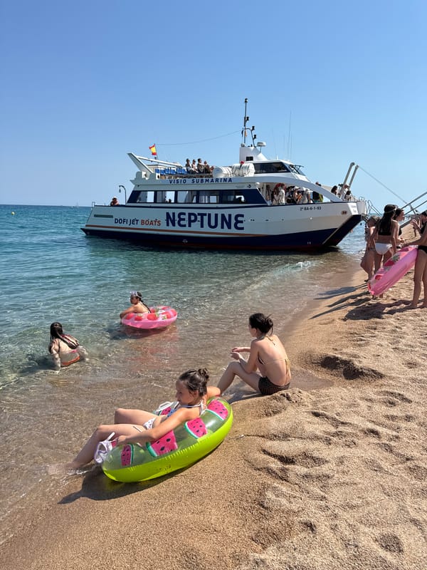 Neptune glass-bottom tour boat active at Blanes beach