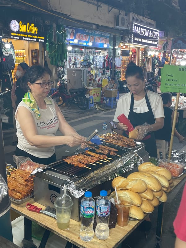 Evening street food market scene in Hanoi