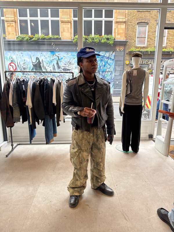 Delivery worker unloads orange bags in London retail area