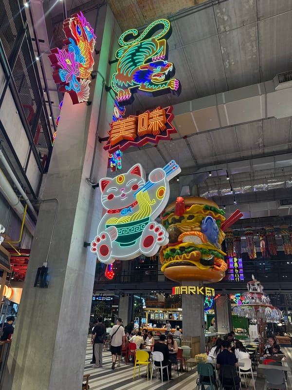 Bangkok food market displays colorful Asian neon signage