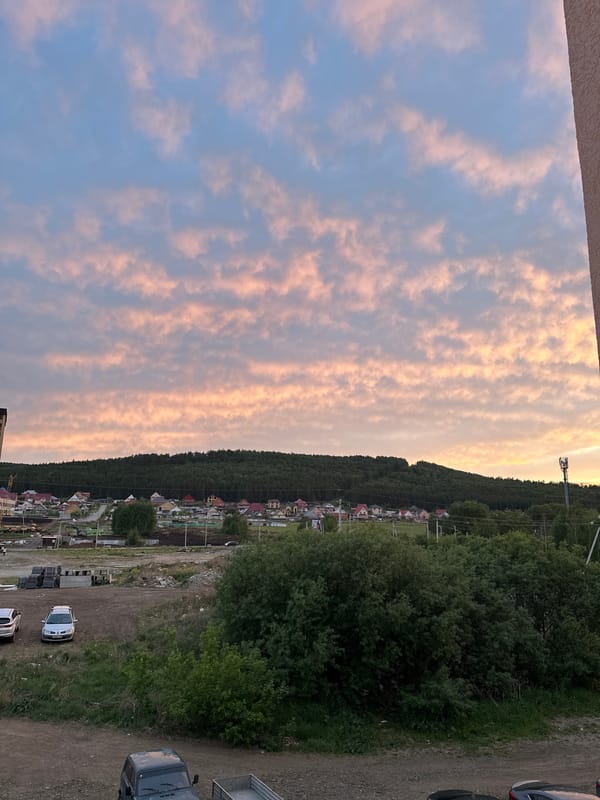 Dramatic sunset photographed over unknown hillside town Friday evening