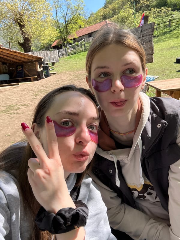 Two women pose for selfie with purple patches in Serbia