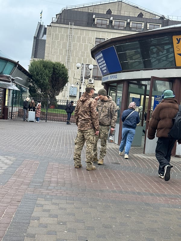 Morning conversation observed on Kyiv street sidewalk