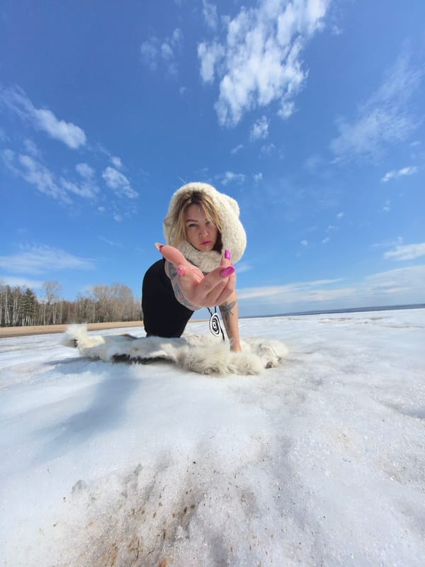 Woman poses in snowy landscape in Noviy, Russia