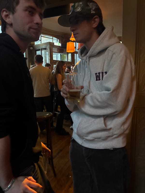 Evening crowd gathers at London pub with queue outside